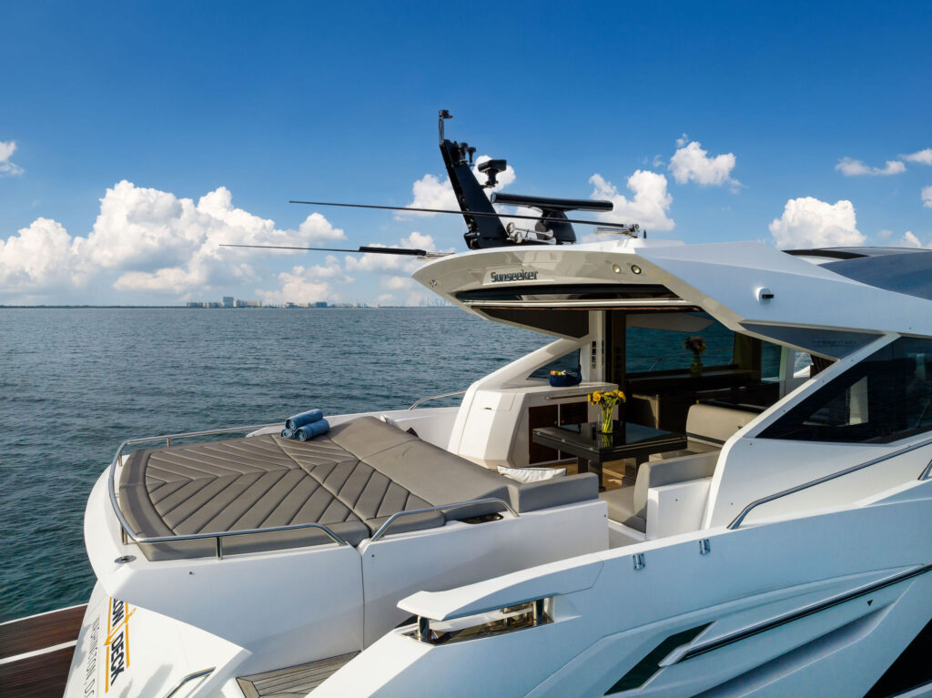 Spacious aft deck with shaded seating and water platform access on Miami Sunseeker yacht charter