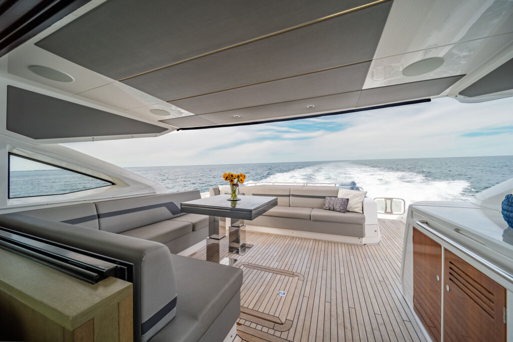 Spacious aft deck with shaded seating and water platform access on Miami Sunseeker yacht charter