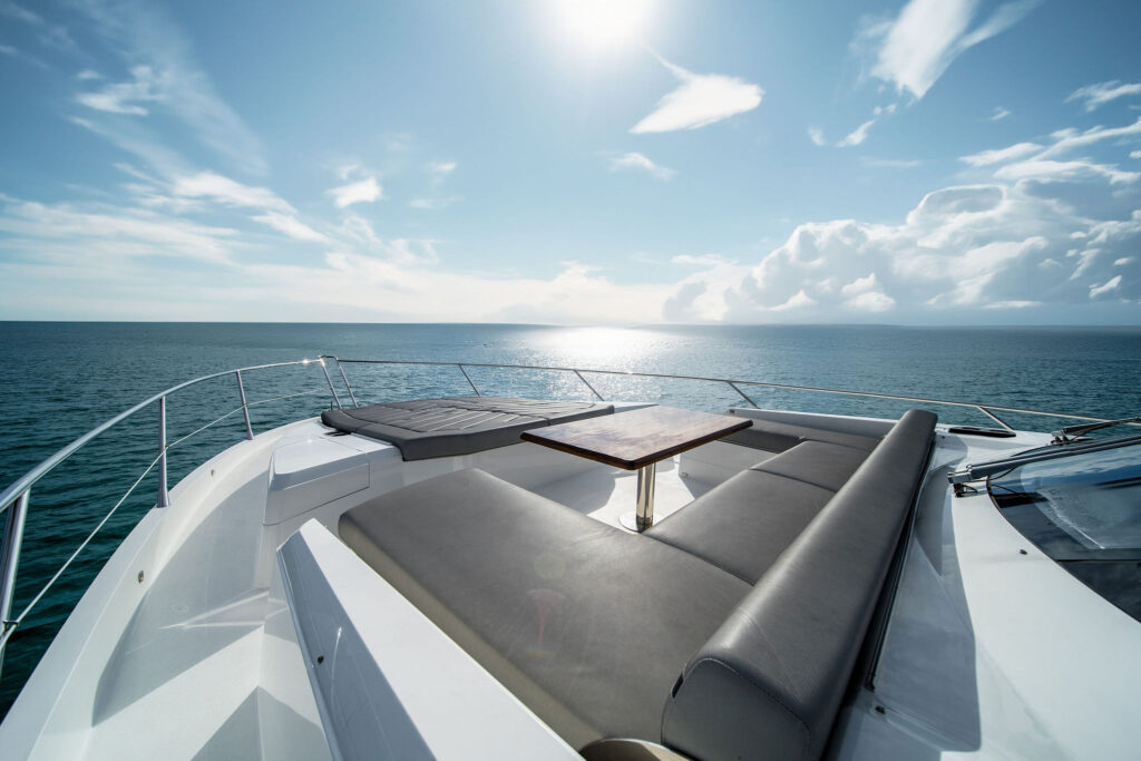 Premium sunbathing cushions and lounge seating on bow deck of 74-foot Sunseeker yacht charter